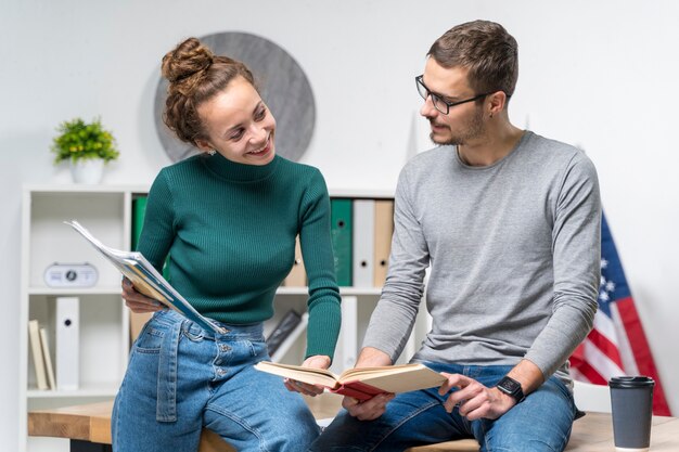 medium-shot-smiley-friends-with-books_23-2148389026